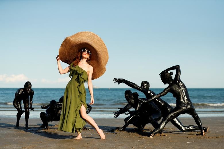 Actor Lotte Verbeek poses with performers at the beach for the shooting of the movie "The Book of Vision" in the Critics' Week during the Venice Film Festival, September 3, 2020. REUTERS/Yara Nardi